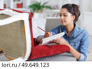 close-up of young beautiful woman writing in notebook. Стоковое фото, агентство Ingram Publishing / Фотобанк Лори