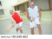 team of men playing basque squash. Стоковое фото, агентство Ingram Publishing / Фотобанк Лори