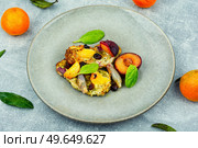 Meat chop roasted with plums and tangerine. Baked meat steak. Meat baked with fruits. Стоковое фото, агентство Ingram Publishing / Фотобанк Лори