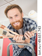 smiling fun happy man with paint brushes. Стоковое фото, агентство Ingram Publishing / Фотобанк Лори