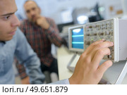 apprentice and teacher working with a radio. Стоковое фото, агентство Ingram Publishing / Фотобанк Лори