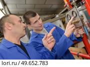 two men holding timber on woodworking machine. Стоковое фото, агентство Ingram Publishing / Фотобанк Лори