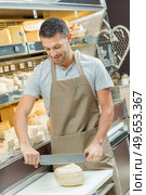 a cheese shop worker at work. Стоковое фото, агентство Ingram Publishing / Фотобанк Лори