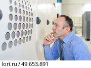 smiling professional checking finishing at factory. Стоковое фото, агентство Ingram Publishing / Фотобанк Лори