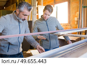 carpentry supervisor inspecting finish product. Стоковое фото, агентство Ingram Publishing / Фотобанк Лори