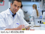 portrait of doctor documenting scientific experiment. Стоковое фото, агентство Ingram Publishing / Фотобанк Лори