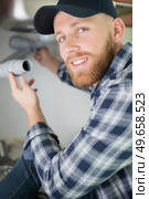 handsome plumber smiling at the camera. Стоковое фото, агентство Ingram Publishing / Фотобанк Лори
