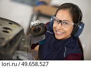 coachbuilding taining girl standing in garage. Стоковое фото, агентство Ingram Publishing / Фотобанк Лори