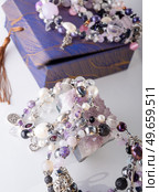 stylish jewelry bracelets with semiprecious and amethyst  crystal around  white background. hobby and fashion concept. close up. Стоковое фото, агентство Ingram Publishing / Фотобанк Лори