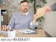 happy businessman accepting an envelop. Стоковое фото, агентство Ingram Publishing / Фотобанк Лори