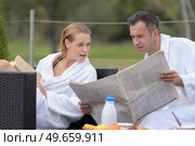 senior couple in bathrobe standing on a pontoon. Стоковое фото, агентство Ingram Publishing / Фотобанк Лори