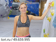 portrait of female climber by indoor wall. Стоковое фото, агентство Ingram Publishing / Фотобанк Лори