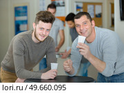 men having cup of drink during break. Стоковое фото, агентство Ingram Publishing / Фотобанк Лори