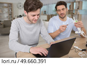 engineer and technician working together on drone in office. Стоковое фото, агентство Ingram Publishing / Фотобанк Лори