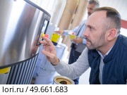 man checking tank at the factory. Стоковое фото, агентство Ingram Publishing / Фотобанк Лори