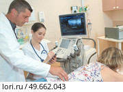 female doctor making ultrasound investigation in medical clinic. Стоковое фото, агентство Ingram Publishing / Фотобанк Лори