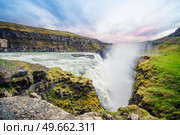 The Icelandic waterfall Gullfoss surrounded by green moss on the cliffs in the sunset. Стоковое фото, агентство Ingram Publishing / Фотобанк Лори
