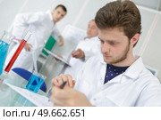 young male scientist or graduate student in lab. Стоковое фото, агентство Ingram Publishing / Фотобанк Лори