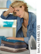 beautiful woman is tired of ironing every day. Стоковое фото, агентство Ingram Publishing / Фотобанк Лори