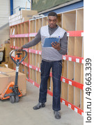 production order picker reading the clipboard. Стоковое фото, агентство Ingram Publishing / Фотобанк Лори
