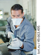 male worker buffering a car. Стоковое фото, агентство Ingram Publishing / Фотобанк Лори