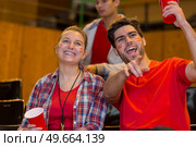 sports supporters wearing facepaint in the stands watching game. Стоковое фото, агентство Ingram Publishing / Фотобанк Лори