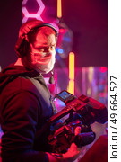 masked cameraman is filming a television show in the studio. TV. Стоковое фото, агентство Ingram Publishing / Фотобанк Лори