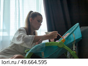 Nurturing Moments Early Morning Feeding Time With Baby in Swing. Стоковое фото, фотограф Aleksandr Golubev / Фотобанк Лори