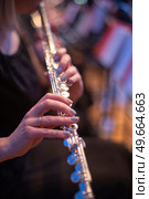 girl playing the flute at a concert. Стоковое фото, агентство Ingram Publishing / Фотобанк Лори