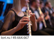 girl playing the flute at a concert. Стоковое фото, агентство Ingram Publishing / Фотобанк Лори
