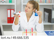 female scientist examining a three dimensional model of dna. Стоковое фото, агентство Ingram Publishing / Фотобанк Лори
