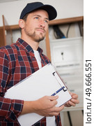 portrait of electrician standing next to fuseboard. Стоковое фото, агентство Ingram Publishing / Фотобанк Лори
