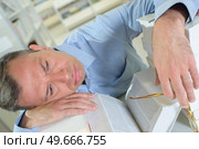 Man layed on a book. Стоковое фото, агентство Ingram Publishing / Фотобанк Лори