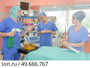 surgeons standing in operation room at the hospital. Стоковое фото, агентство Ingram Publishing / Фотобанк Лори