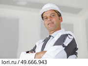 low angle view of middle aged male tradesman. Стоковое фото, агентство Ingram Publishing / Фотобанк Лори