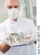 Dentist presenting his tools. Стоковое фото, агентство Ingram Publishing / Фотобанк Лори