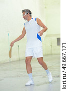 a man is playing pala. Стоковое фото, агентство Ingram Publishing / Фотобанк Лори