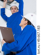 young male electrician with female mentor. Стоковое фото, агентство Ingram Publishing / Фотобанк Лори