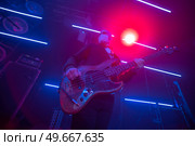 During Coronavirus (COVID-19) Musician plays a mask. guitarist at a concert. Стоковое фото, агентство Ingram Publishing / Фотобанк Лори