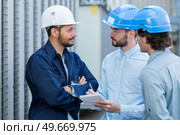 three engineers checking plans with documents at construction site. Стоковое фото, агентство Ingram Publishing / Фотобанк Лори