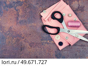 Home sewing kit, scissors, needles and buttons. Space for text. Sewing tools and accessories, copy space. Стоковое фото, агентство Ingram Publishing / Фотобанк Лори