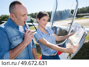 happy couple in airfield looking at map. Стоковое фото, агентство Ingram Publishing / Фотобанк Лори