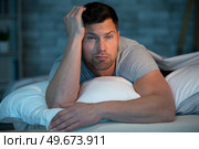 man with sleep problem in his bed at home. Стоковое фото, агентство Ingram Publishing / Фотобанк Лори