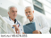 two senior doctors talking together. Стоковое фото, агентство Ingram Publishing / Фотобанк Лори
