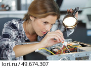 female technician working with transistor. Стоковое фото, агентство Ingram Publishing / Фотобанк Лори