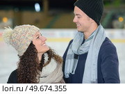 Couple in woolly hats on ice rink. Стоковое фото, агентство Ingram Publishing / Фотобанк Лори