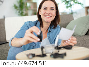 happy woman screws the top of a furniture. Стоковое фото, агентство Ingram Publishing / Фотобанк Лори