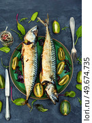 Two appetizing mackerel fish baked with kiwi pieces. Japanese cuisine. Cooking scomber fish with kiwi. Стоковое фото, агентство Ingram Publishing / Фотобанк Лори