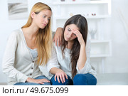friend comforting sorrowful young female teenager. Стоковое фото, агентство Ingram Publishing / Фотобанк Лори