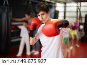 Boy posing during training in boxing gloves. Стоковое фото, фотограф Яков Филимонов / Фотобанк Лори